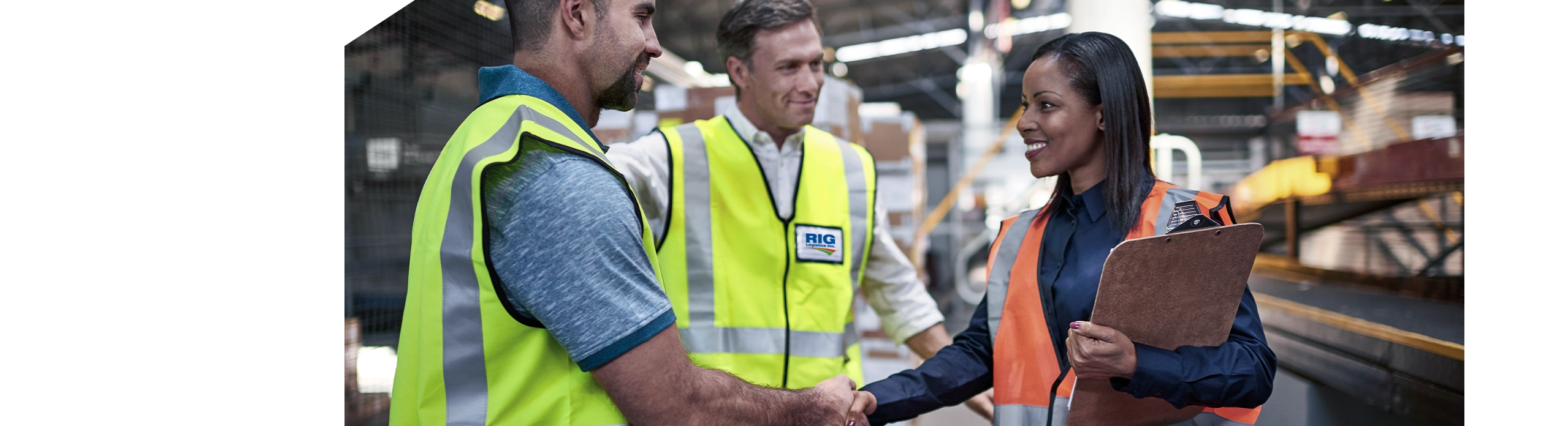 Three RIG Logistics employees meeting and shaking hands in warehousing facility